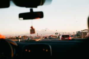 Voiture roulant vers montagnes coucher soleil