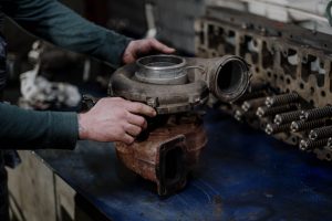 Mécanicien réparant un turbocompresseur en atelier